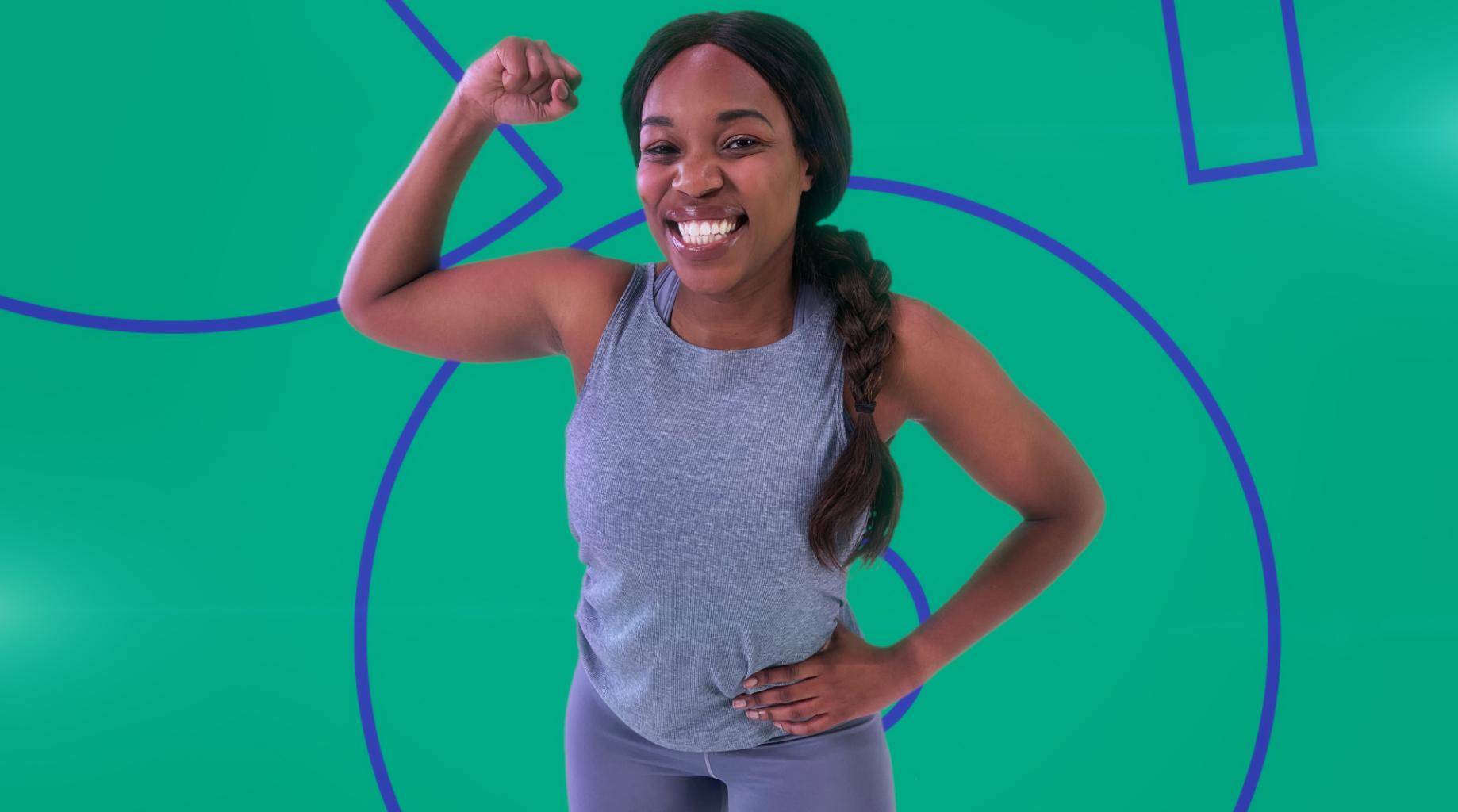 A woman smiling to camera with one arm raised