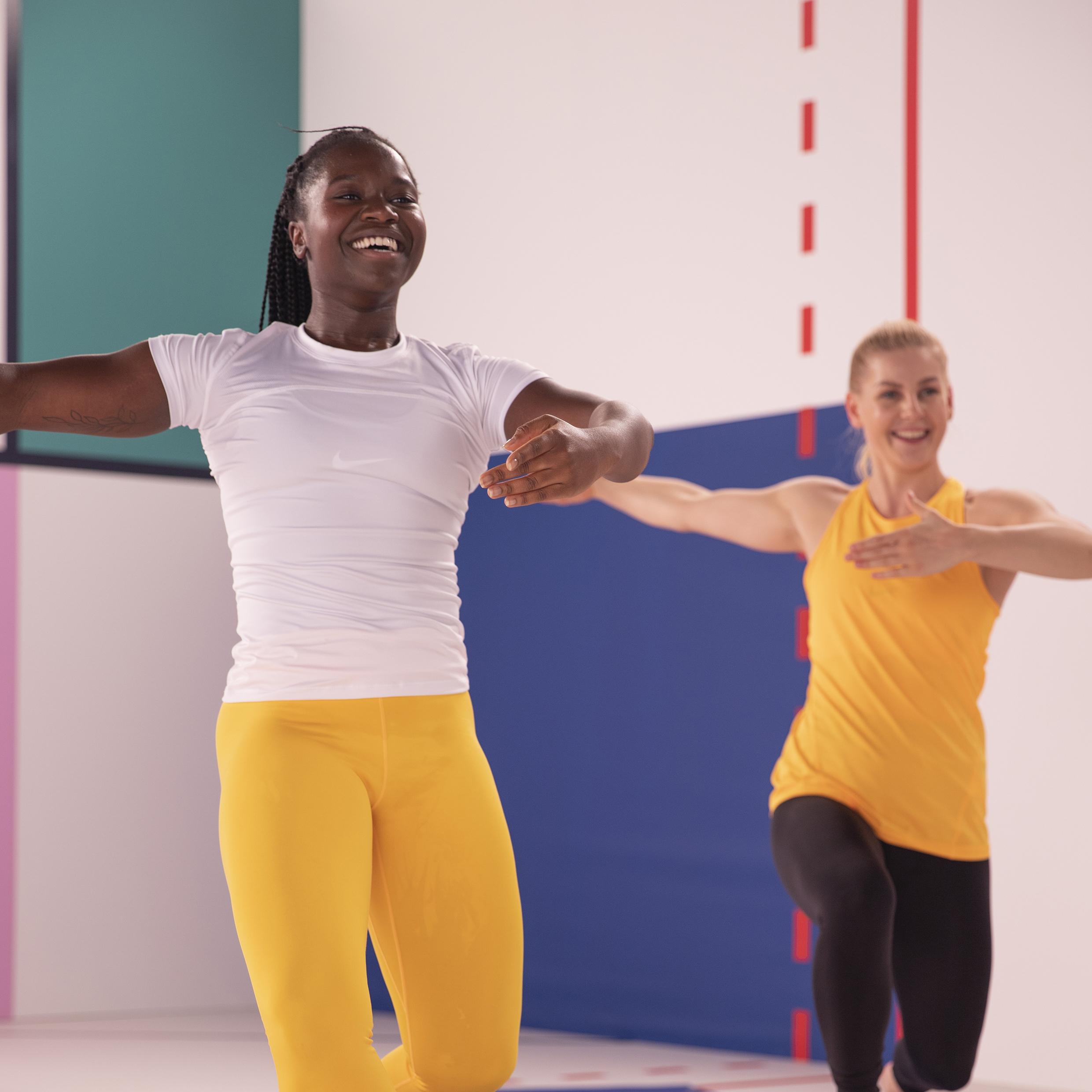 Two women smiling while exercising